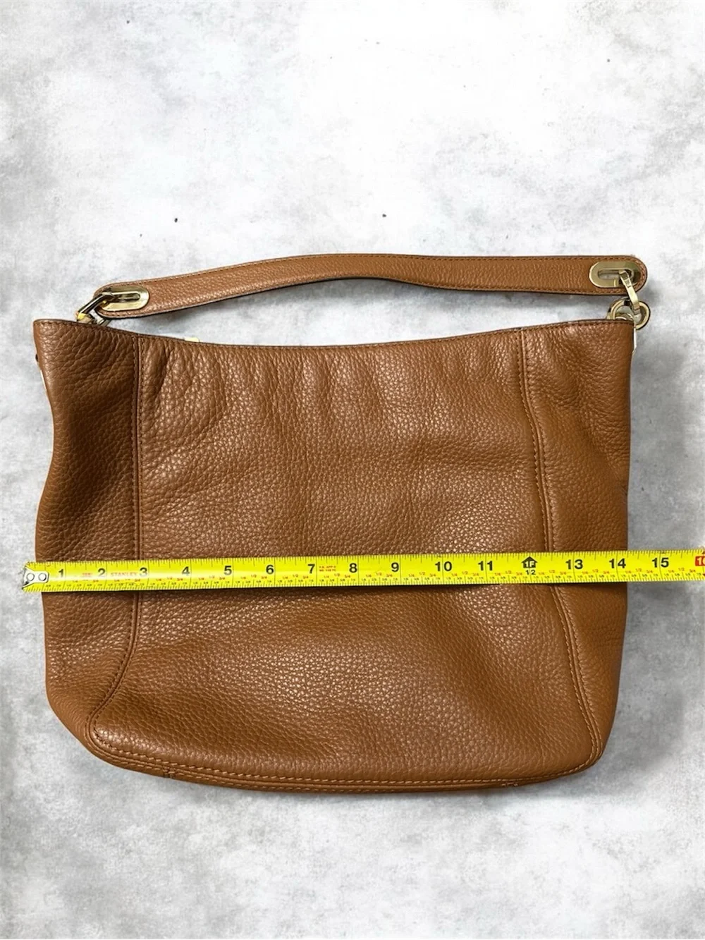 Michael Kors Cognac Pebbled Leather Shoulder Bag with Gold logo on the side.